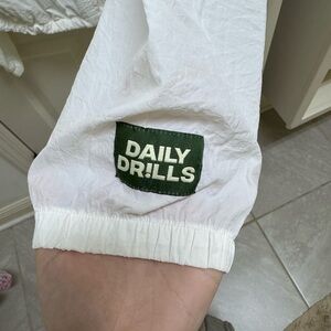 Daily Drills White Windbreaker with Green Patch